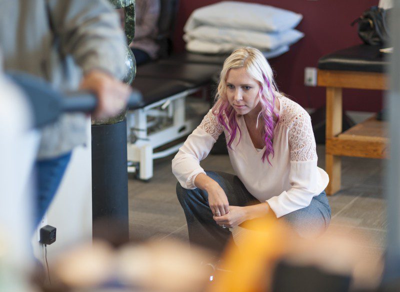 woman kneeling looking at the ground