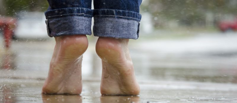 Plantar Fasciitis, person outside barefoot in the rain